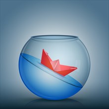 Abstract idea as a red paper origami boat float in a glass bowl with water. Surrounded by the fish tank limitation