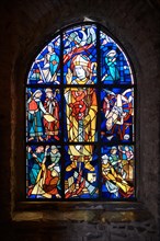 Stained glass pointed arch window with scenes of St. Aegidius' murder