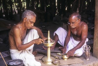 Men making oil lamp