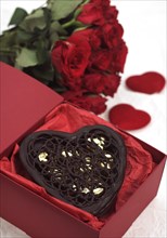 Chocolate heart and red roses