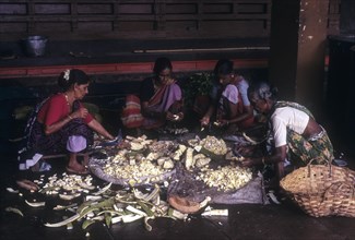 Women cutting raw jackfruit to make side dish of lunch at Madhur Sri Anantheshwara Vinayaka Temple