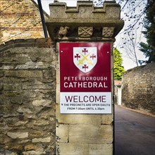 Welcome sign with coat of arms on a wall
