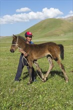 Kyrgyz boy with his foal