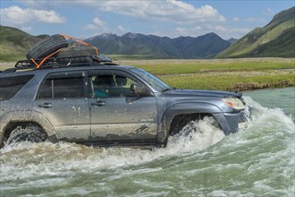 Four-wheel drive crossing a river