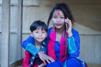 Nepalese woman with her son from the Tharu ethnic group