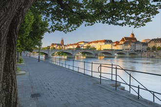 Rhine bank promenade with view of old town with Basel Cathedral
