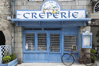 Old bicycle in front of a Creperie