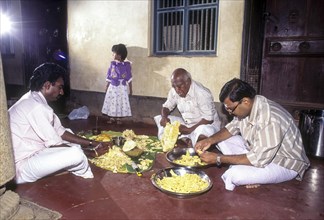 Nattukottai Chettiars Nagarathars to separate the jack fruit to distribute it to the guests of wedding feast in Chettinad