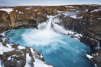 Aldeyjarfoss waterfall by the SkjsslfandafljÂ¾t river in winter in the north-eastern region