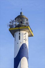 Lantern of the white-blue lighthouse Lange Nelle in the harbour of Ostend at the Belgian North Sea coast