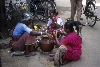 An old woman selling Neera at Madurai