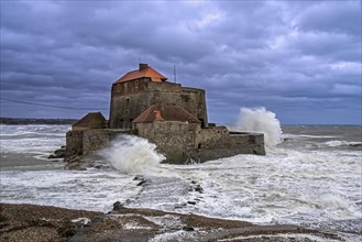 Waves crashing against Vauban's Fort Mahon near Ambleteuse during a winter storm on the North Sea coast