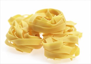 Tagliatelles pasta against white background