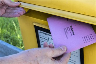 Envelope with postal voting documents for the Bundestag election on 26.09.2021 is placed in a letterbox
