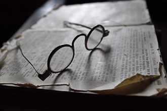 Historical glasses on old book