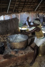 A man preparing wheat halva halwa for a feast in Chettinad