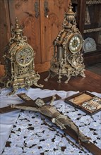 Antique grandfather clocks and crucifix