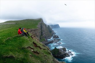 3 Walkers sitting overlooking Beinisforo Cliffs