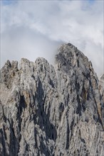 Steep rocky peak with summit cross Partenkirchner Dreitorspitze
