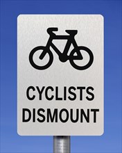 Cyclists dismount sign