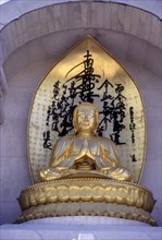 Gilded statue of Buddha on Vishwa Shanti Stupa