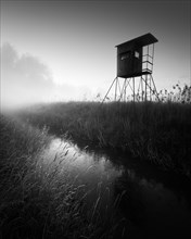 German floodplain landscape in Brandenburg with high seat on the Nuthe in black and white
