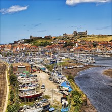 Village view of Whitby with harbour and view of the ruins of Whitby Abbey