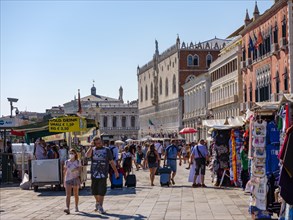 Tourists and stalls in front of the Doge's Palace on the Rive degli Schiavoni waterfront