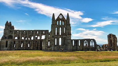 Ruin of the Gothic monastery Whitby Abbey with visitors