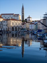 Bell tower of St. George's Cathedral reflected in the harbour basin