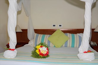 Bouquet of flowers on hotel bed