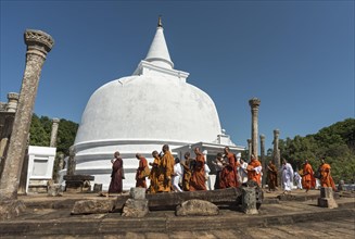 Buddhist monks walking around the Lankaramaya Dagoba