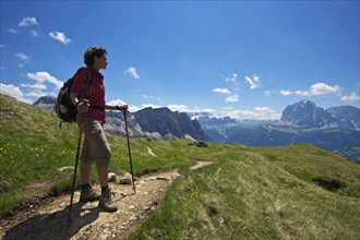 Hiking on the Seceda with view of Langkofel and Plattkofel