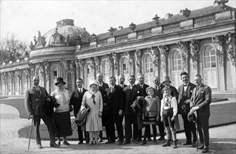 Group with tourists posing in front of Sanssouci Palace