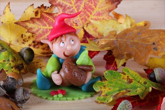 Marzipan gnome and autumn leaves