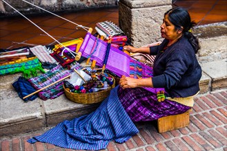 Woman weaving with loom
