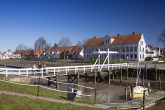 The old historic white bridge over the Toenning peat harbour