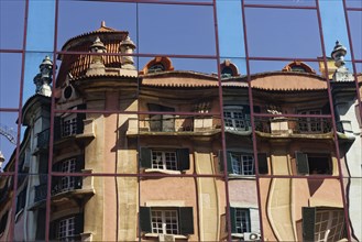 Mirror imaging in the glass facade of the mall Monumental