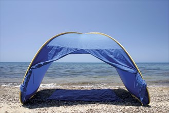 An empty tent on sand
