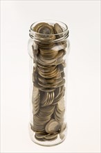 A jar of Turkish coins on an isolated white background