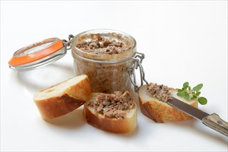 A jar of meat terrine and slices of bread