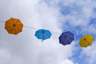 Coloured umbrellas in the sky