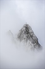 Summit in clouds and fog