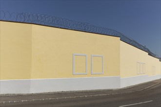 Prison wall with painted window frames