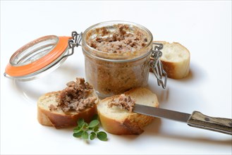 A jar of meat terrine and slices of bread