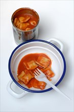 Ravioli in bowl and opened tin can