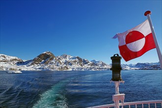 Greenland national flag and coastal landscape with snow