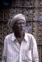 Tribal man smoking beedi