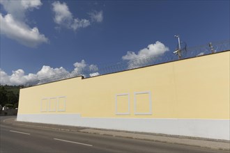 Prison wall with painted window frames