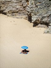 Sandy beach beach with umbrellas and cliffs